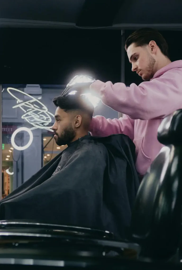 Expert barber at work with client in his chair.