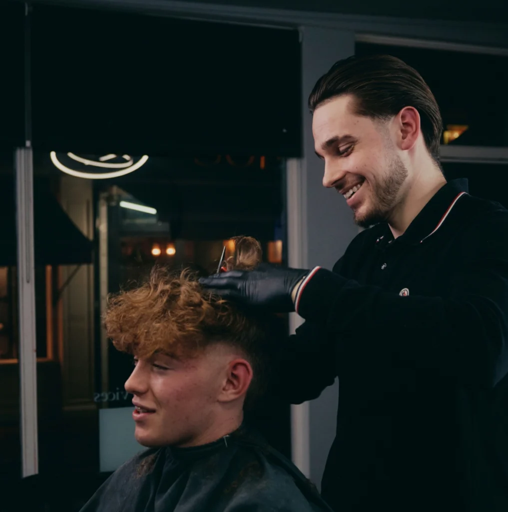 Barber cutting hair at Jimmy Marum's academy.